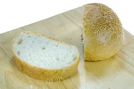 slices  bread with sesame seeds on wooden board over white