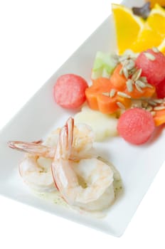 summer salad with boiled shrimp and mixed fruits on plate over white background 