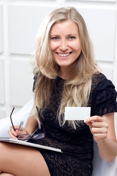 Portrait of smiling business woman giving blank business card