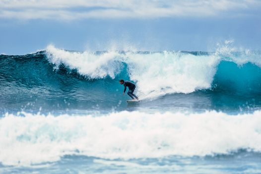 Surf on a large blue ocean wave