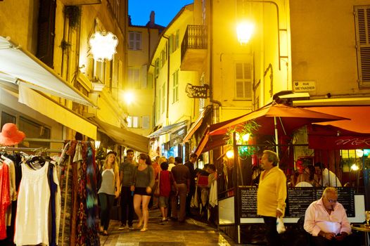 Cannes, France - September 15 2013: Tourists visit local shops in Cannes old city center. Currently the city is hosting Festival of chefs.