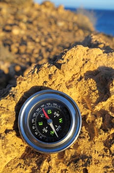 Orientation Concept Metal Compass on a Rock in the Desert