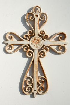 A white painted steel cross with rust in Cotacachi, Ecuador