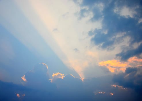 Sun beam at sunset sky