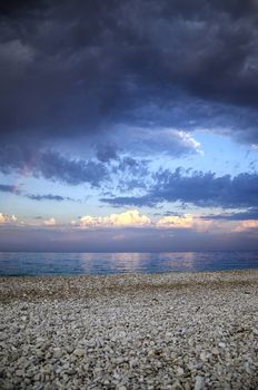 View from beach on a changing weather with rainbow.