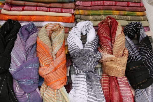 Patterned, colorful handmade scarves for sale at the outdoor craft market in Otavalo, Ecuador