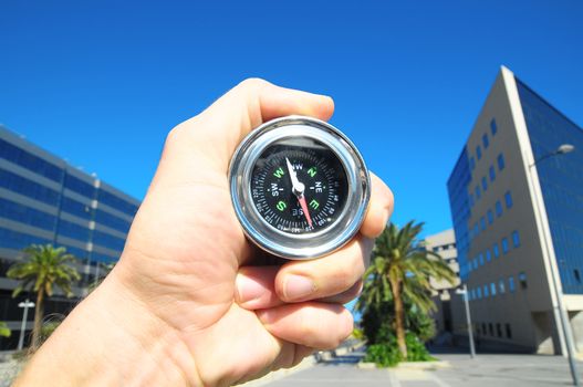 Orientation Concept a Male Hand Holding a Metal Compass in a City