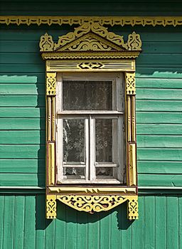 Window with traditional carved platbands in a wooden house, Tutaev, Russia