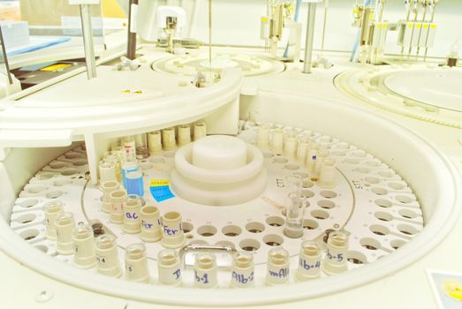 Laboratory medical chromatograph with glass auto sample bottles.