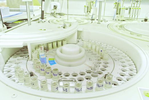 Laboratory medical chromatograph with glass auto sample bottles.