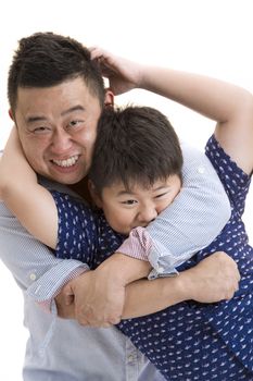 Asian Father and son playing bear hug on isolated white backrgound