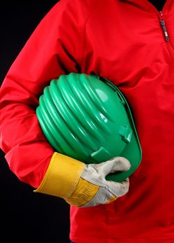 man holding green helmet over black 