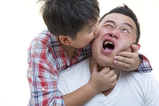 Asian son biting father cheek while playing on isolated white backrgound