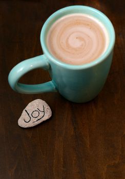 hot chocolate and joy on wood background