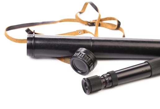 Black cover and spyglass lying. White background.