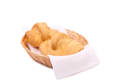 Croissants or crescent rolls in basket. White background.