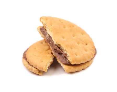 Broken sandwich biscuits with chocolate filling on a white background