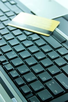 Gold credit card on computer keyboard