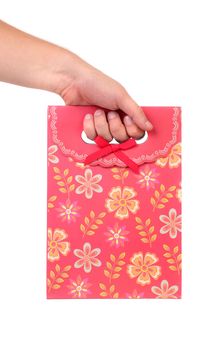 Red gift paper bag with flowers ptint. White background.