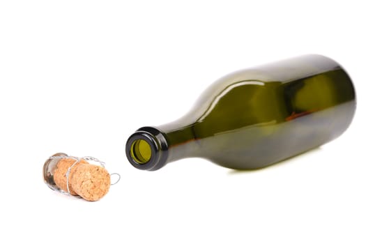 Empty bottle of champagne and muzzle with cork. White background.
