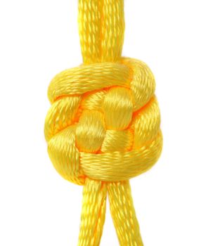 Knot of yellow silk lace. Close up.