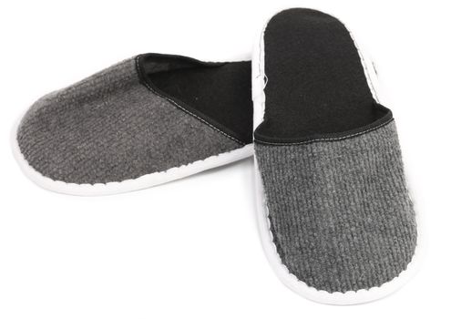 Pair of gray slippers on a white background. Close up.