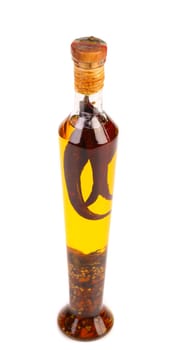 Oil with spicery into bottle. Close up.