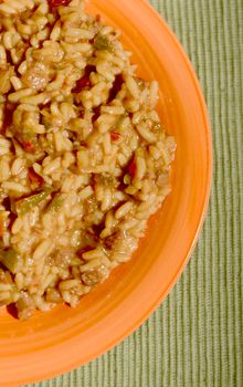 fried rice dish on green table cloth and orange plate