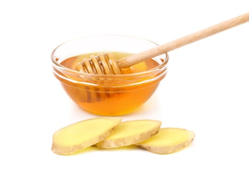 Honey in bowl and a slices ginger root. White background.