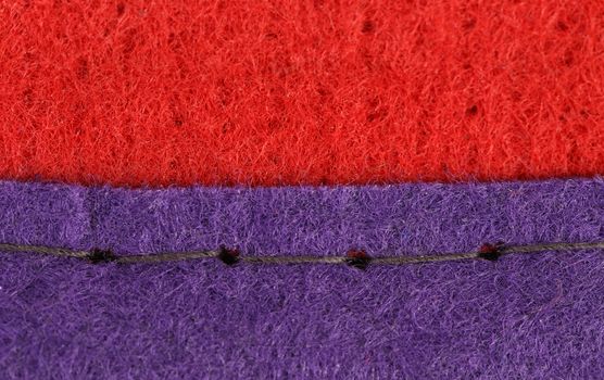 Join of red and blue fabric of artificial fibre.