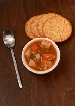 country vegetable stew and crackers on wood