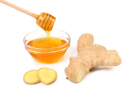 Honey in bowl and a slices ginger root. White background.