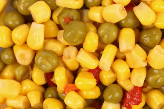Corn and peas with tomatoes. Close up. Background.