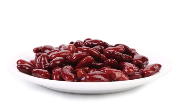 Red beans on a plate. Isolated on a white background.