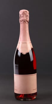 Bottle of pink champange. Isolated on a black background.