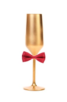 Gold tall wineglass and red bow tie. White background.