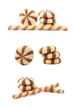Striped chocolate wafer rolls and stake biscuits. White background.