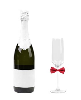 Glass with red bow tie and bottle of champagne. White background.