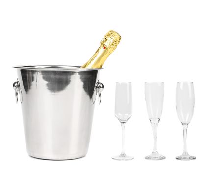 Bottle of champagne in cooler and three glasses. White background.