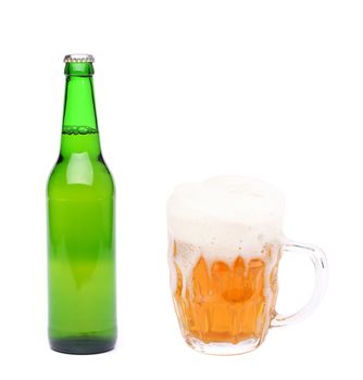 Closed bottle and mug of beer with froth. White background.