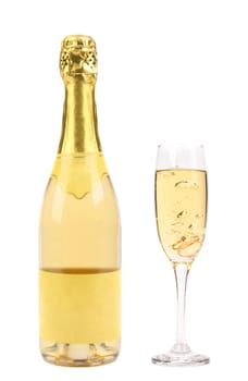Goldish bottle and glass of champagne isolated on a white background.