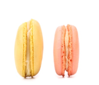 Two various macaron cakes with white cream