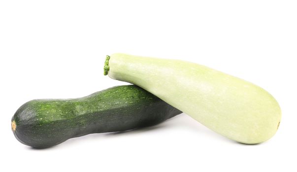 Two fresh courgettes isolated on a white