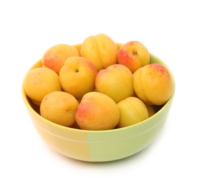Apricots in a deep plate on a white background