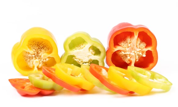 Slices of colorful bell pepper on white background