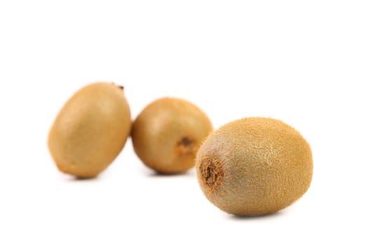Three fresh kiwi on a white background.
