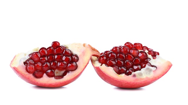 Two pieces of ripe pomegranate isolated on white