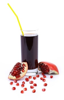 Pomegranate juice in a glass and ripe pomegranate. Isolated