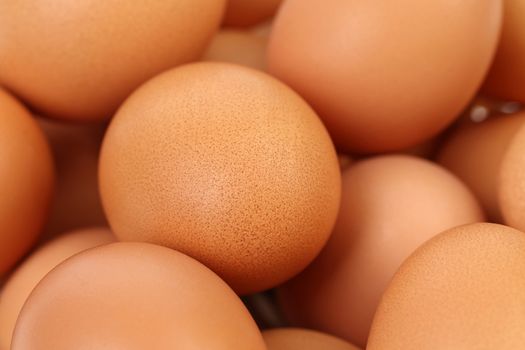 Background of many fresh and brown eggs.