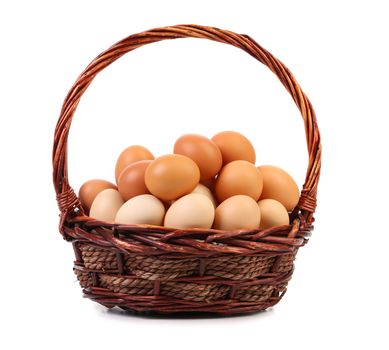 Many eggs in a brown basket on white background